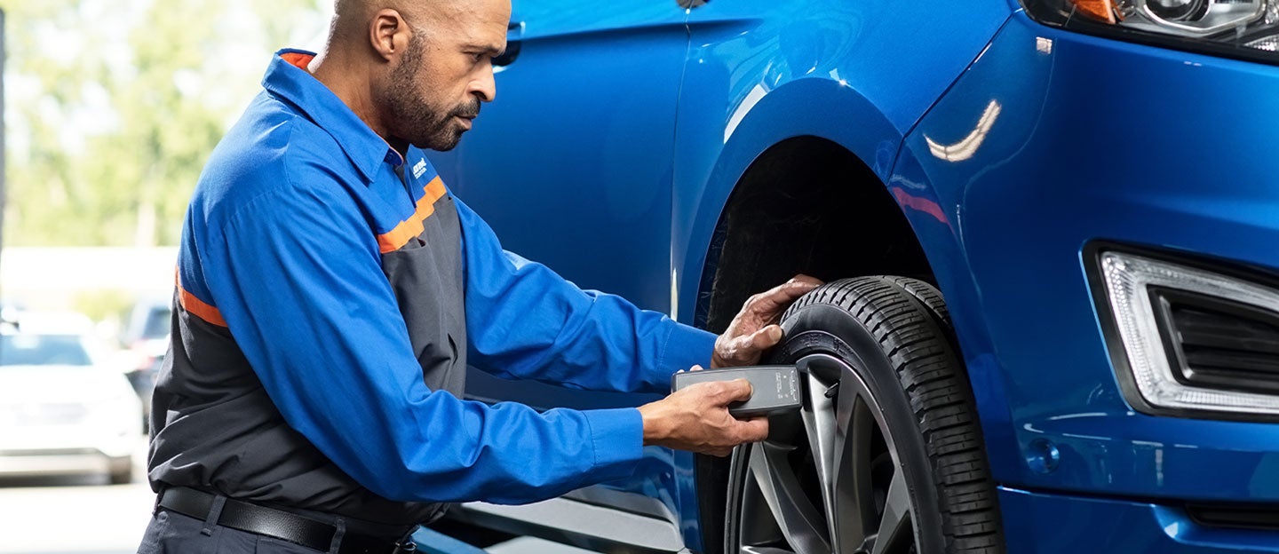 Quick Lane technician servicing a vehicle