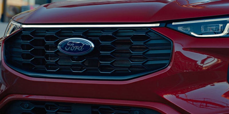 Front view of a red Ford Escape with Ford logo.